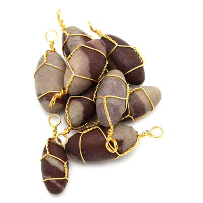 Narmada Lingam Stone Gold Tone Wire Wrapped Pendant  in a pile