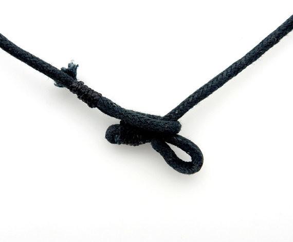 close up of the cord where you can put on and take off this necklace 
