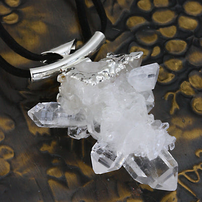 side view of the Crystal Quartz Cluster Necklace  in electroplated silver displayed to show thickness reference