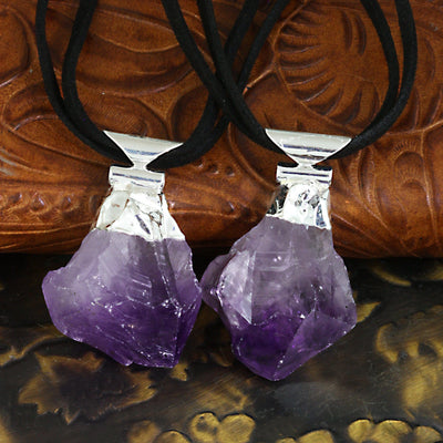 Two Amethyst point necklaces with silver tops and on a black double cord.