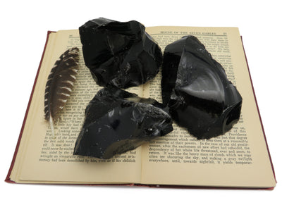 Products Obsidian Chunk - 3 sitting on an open book