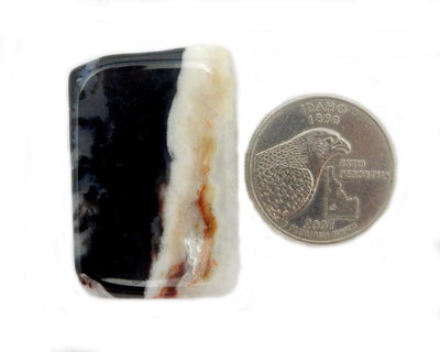Onyx - Black Sardonyx Stone - next to a quarter