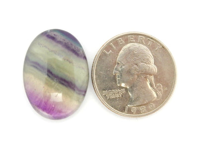 Oval Fluorite Cabochon  next to quarter for size reference