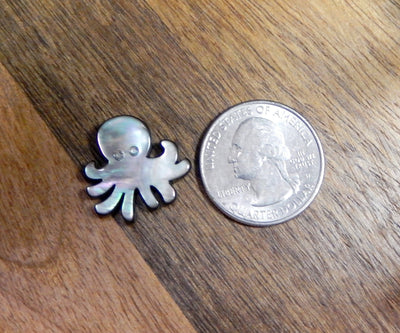 octopus next to a quarter