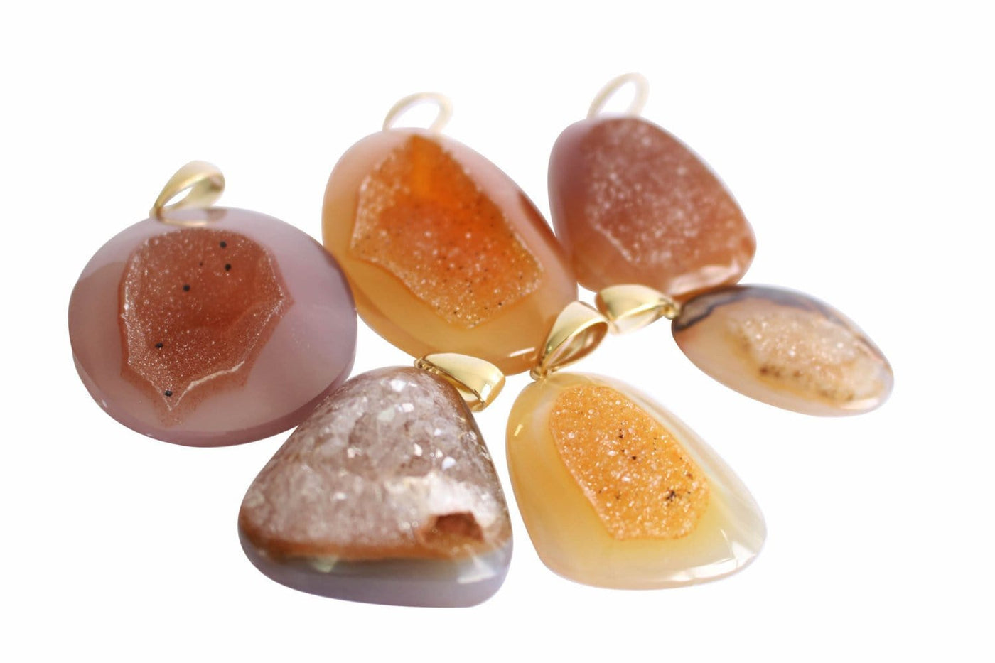 amber natural druzy cabochon being displayed on a white background. 