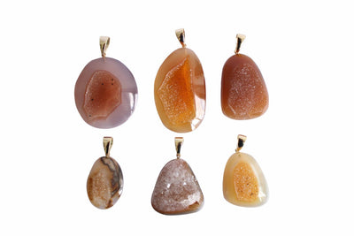 6 amber natural druzy cabochon being displayed on a white background.