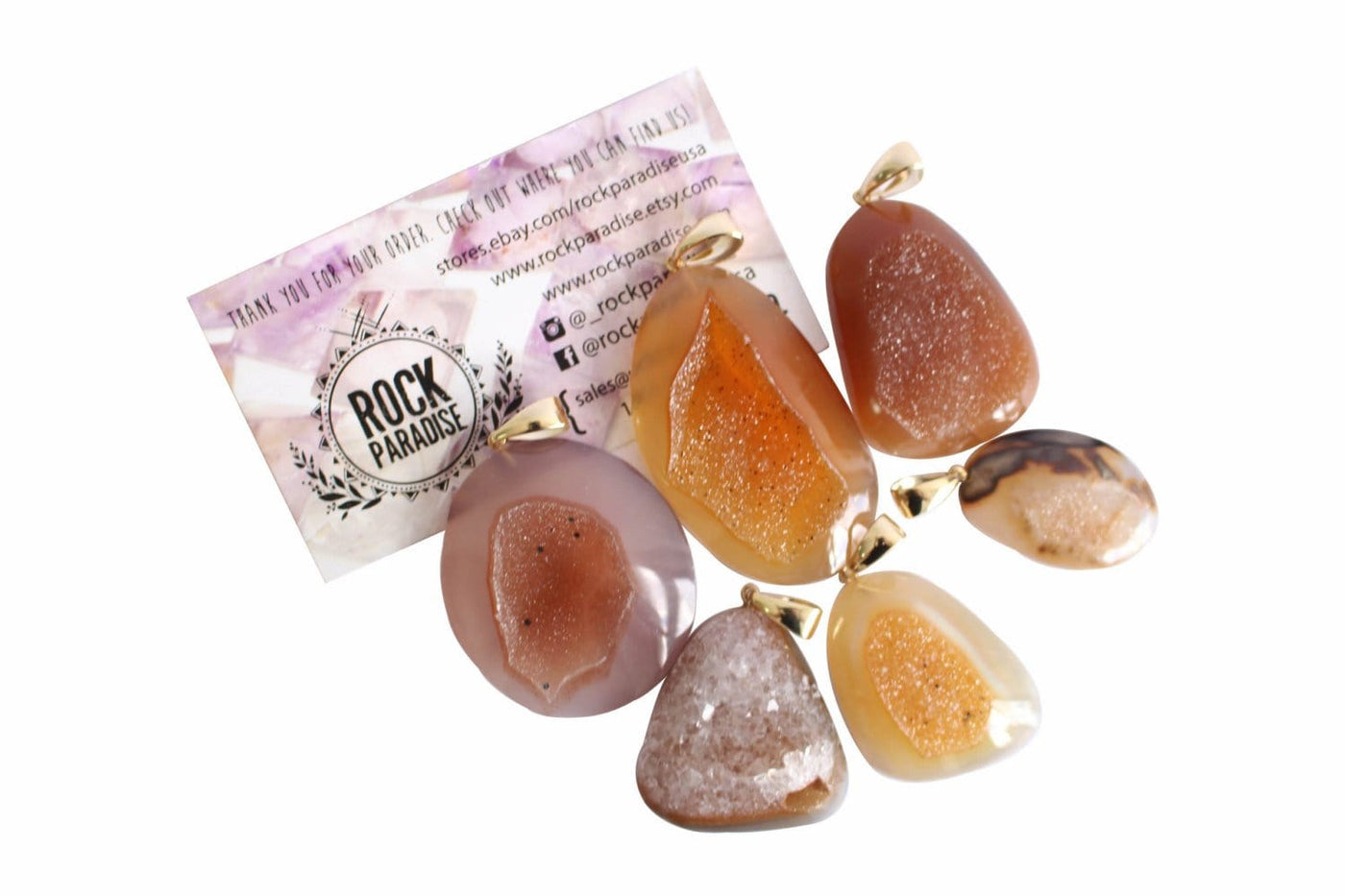 6 amber natural druzy cabochon being displayed on a white background next to one of our Rock paradise business cards.