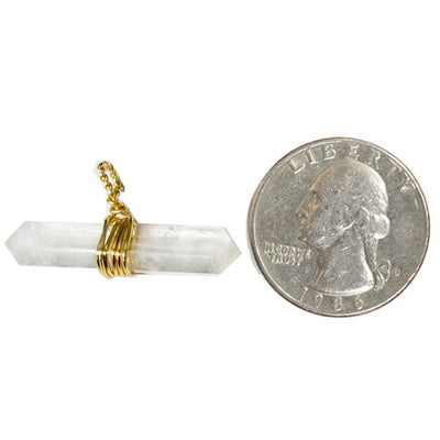 One Crystal Quartz Pendant Next To A Quarter For Size Reference 