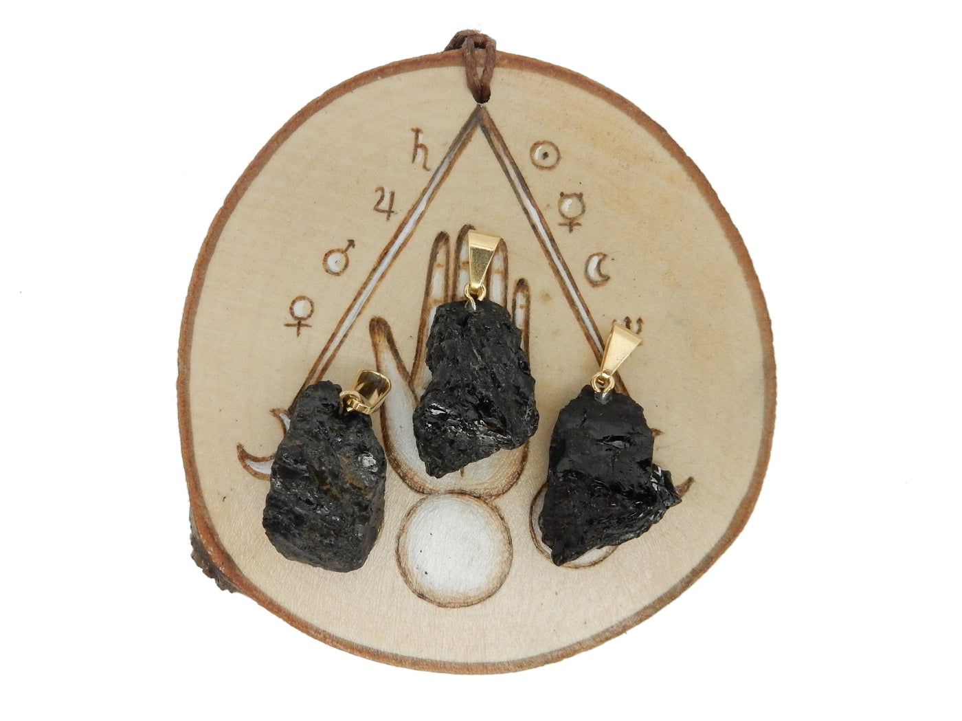 3 tourmaline Rough Stone Pendants with gold bails on wooden coaster