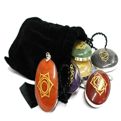 seven chakra stone pendants spilling out of black bag