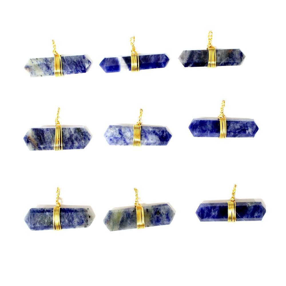 nine sodalite wire wrapped pendants in three rows on a white background for possible variations