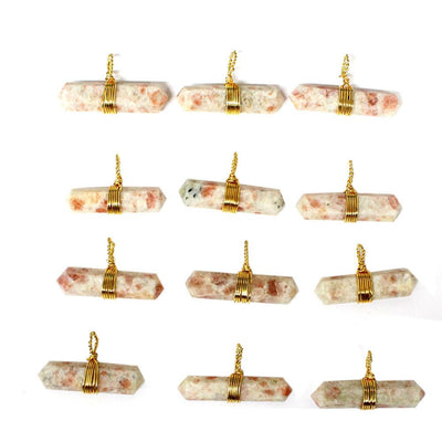 multiple Gold Tone Wire Wrapped Sunstone Double Point Pendants to show various colors patterns and thickness