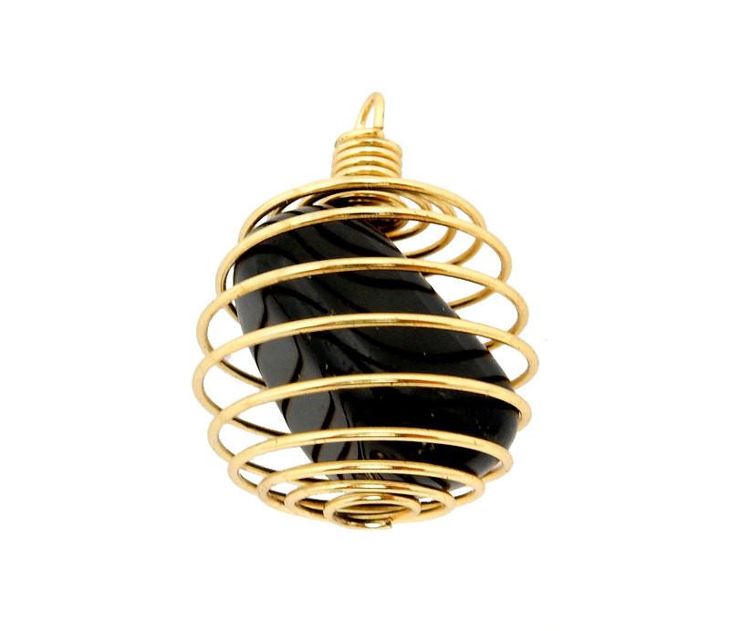 One Gold Toned Wire Tumbled Stone Cage Pendant, with a black tumbled stone within it, on a white surface.