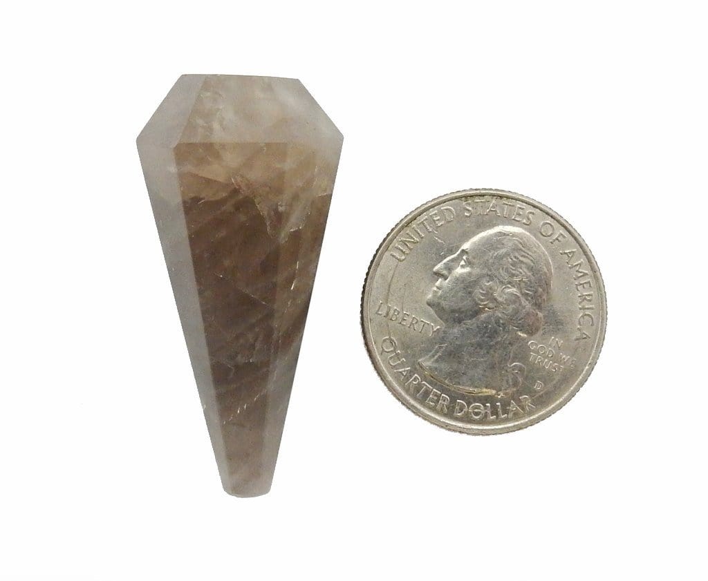 smoky quartz pendulum next to a quarter