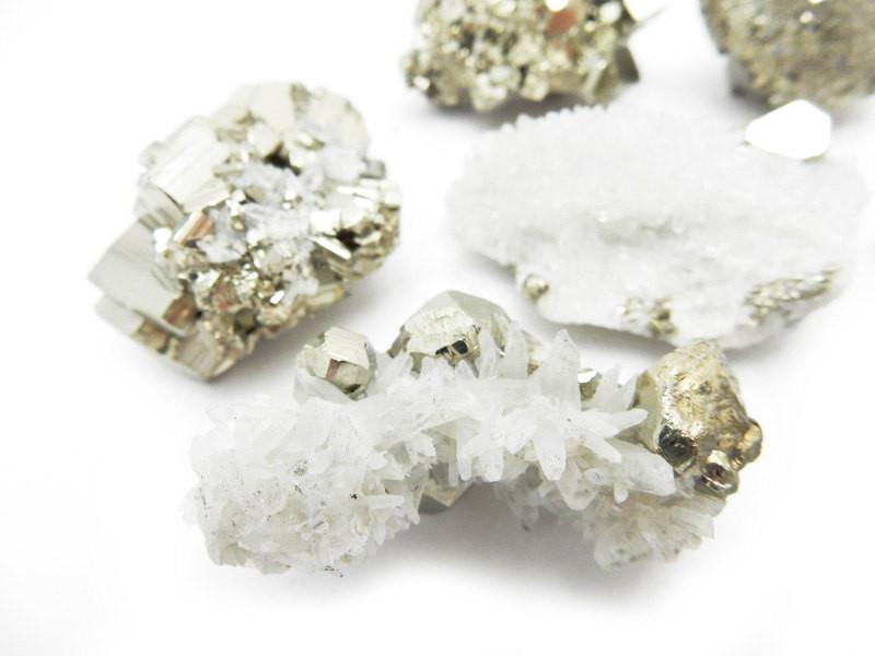 CLose up view of a few Petite Pyrite with Crystal Clusters showing more crystal cluster than pyrite in white background