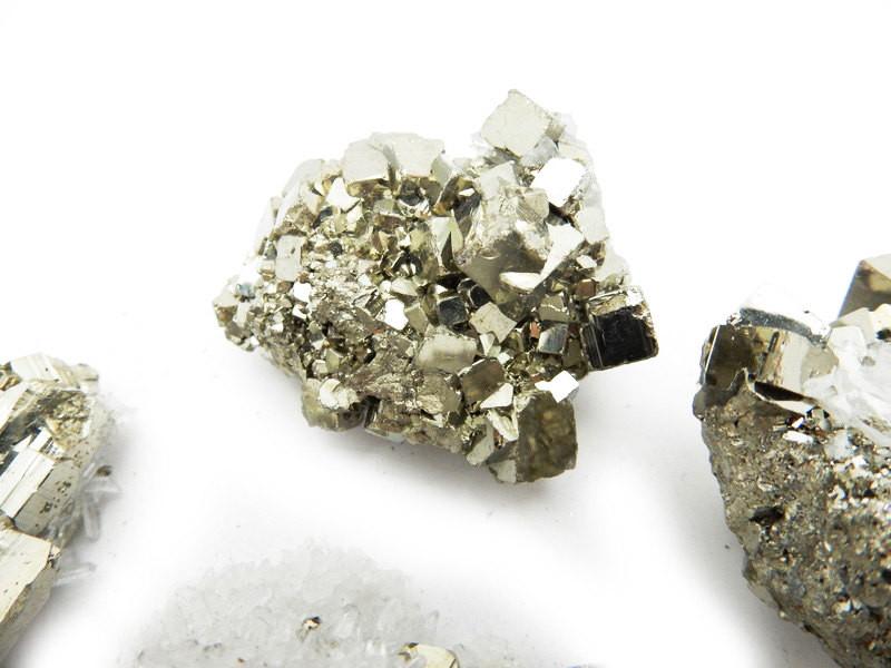 Close up view of a few Petite Pyrite with Crystal Clusters showing more pyrite than crystal clusters in white background 