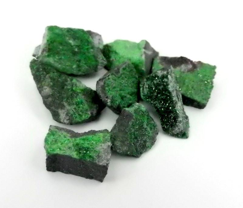 A bundle of Beautiful Rare Stone from Russia Petite Uvarovite Stone on a white background close up view