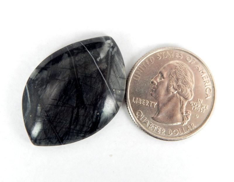 Picasso Marble Stone displayed next to quarter for size reference