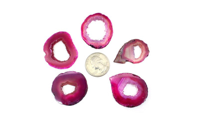 Pink Agate Slice Extra Grade in a circle around a quarter for sizing 