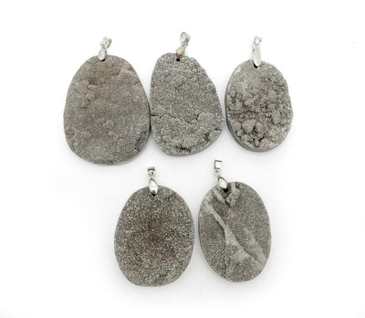 platinum titanium oval pendants displayed to show the differences in the sizes 