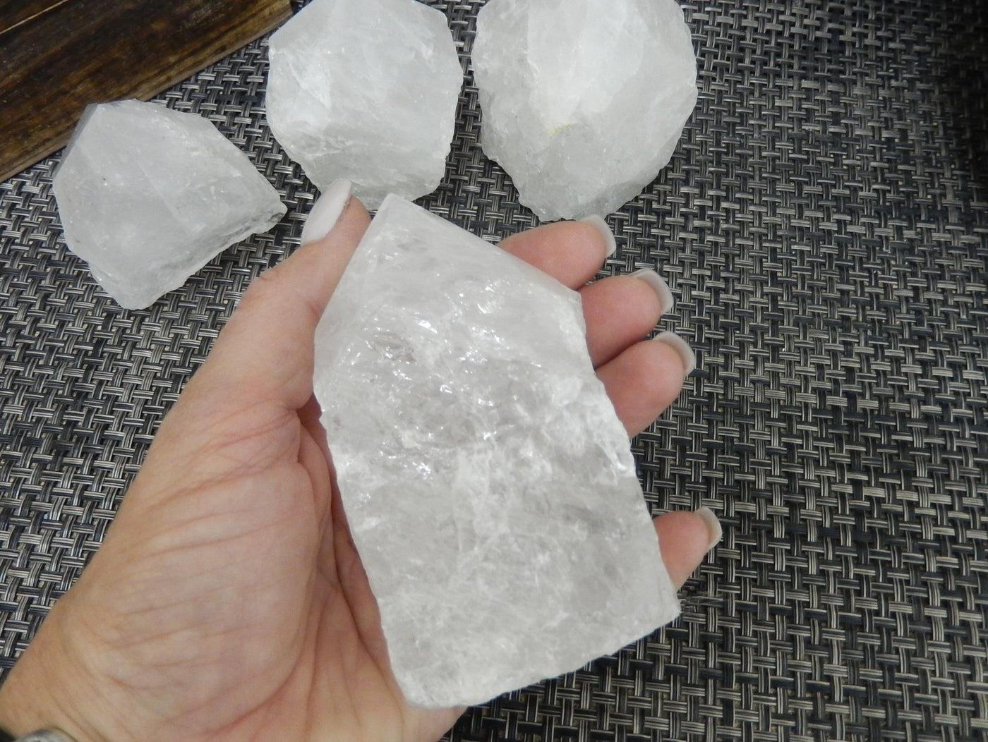 Crystal Quartz Semi Polished Points with a size 400-500g in a hand for size reference