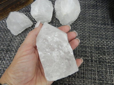Crystal Quartz Semi Polished Points with a size 400-500g in a hand for size reference