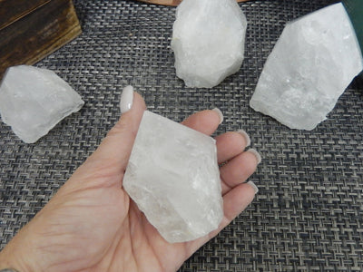Crystal Quartz Semi Polished Points with a 200-300g size in a hand for size reference