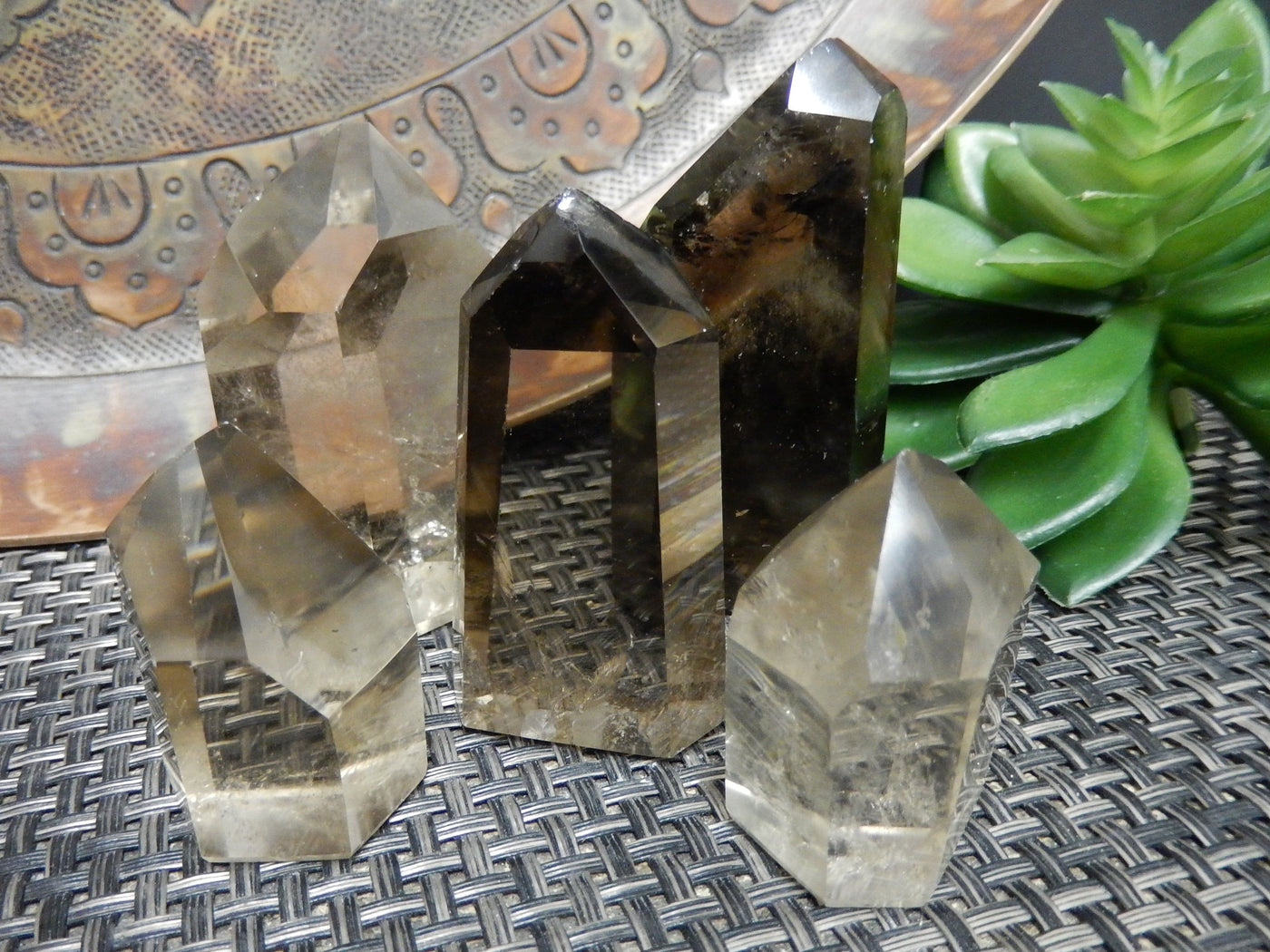 many smokey quartz polished points on display for possible variations