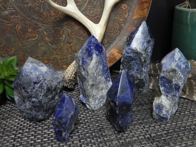 sodalite semi polished points with decorations in the background