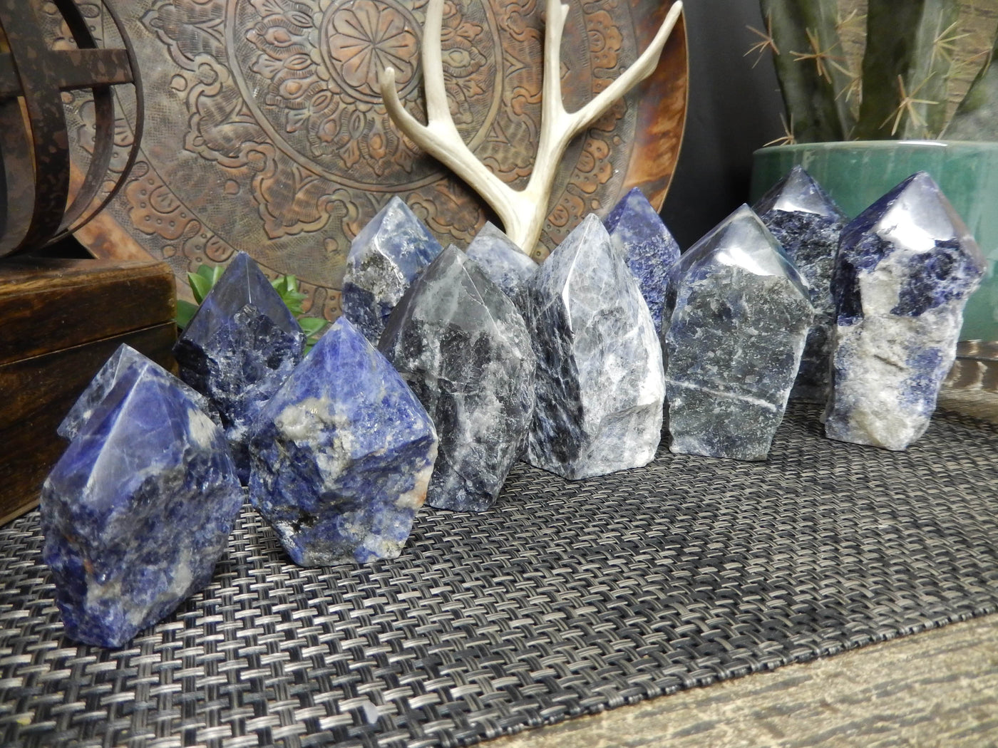 many Sodalite Semi Polished Points lined up on display