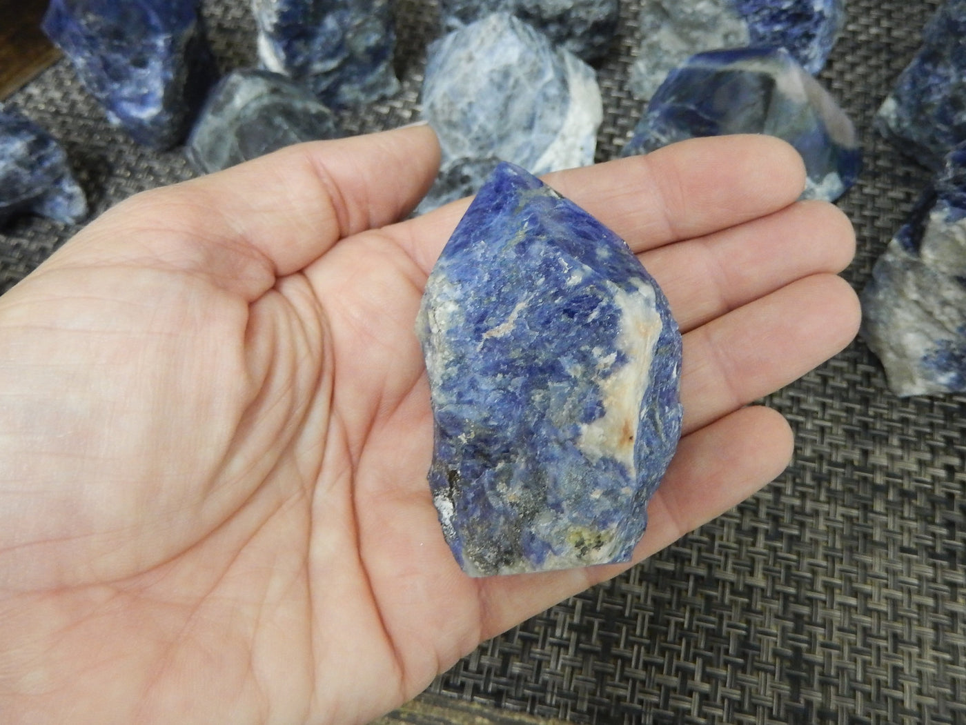 Sodalite Semi Polished Point in a hand for size reference