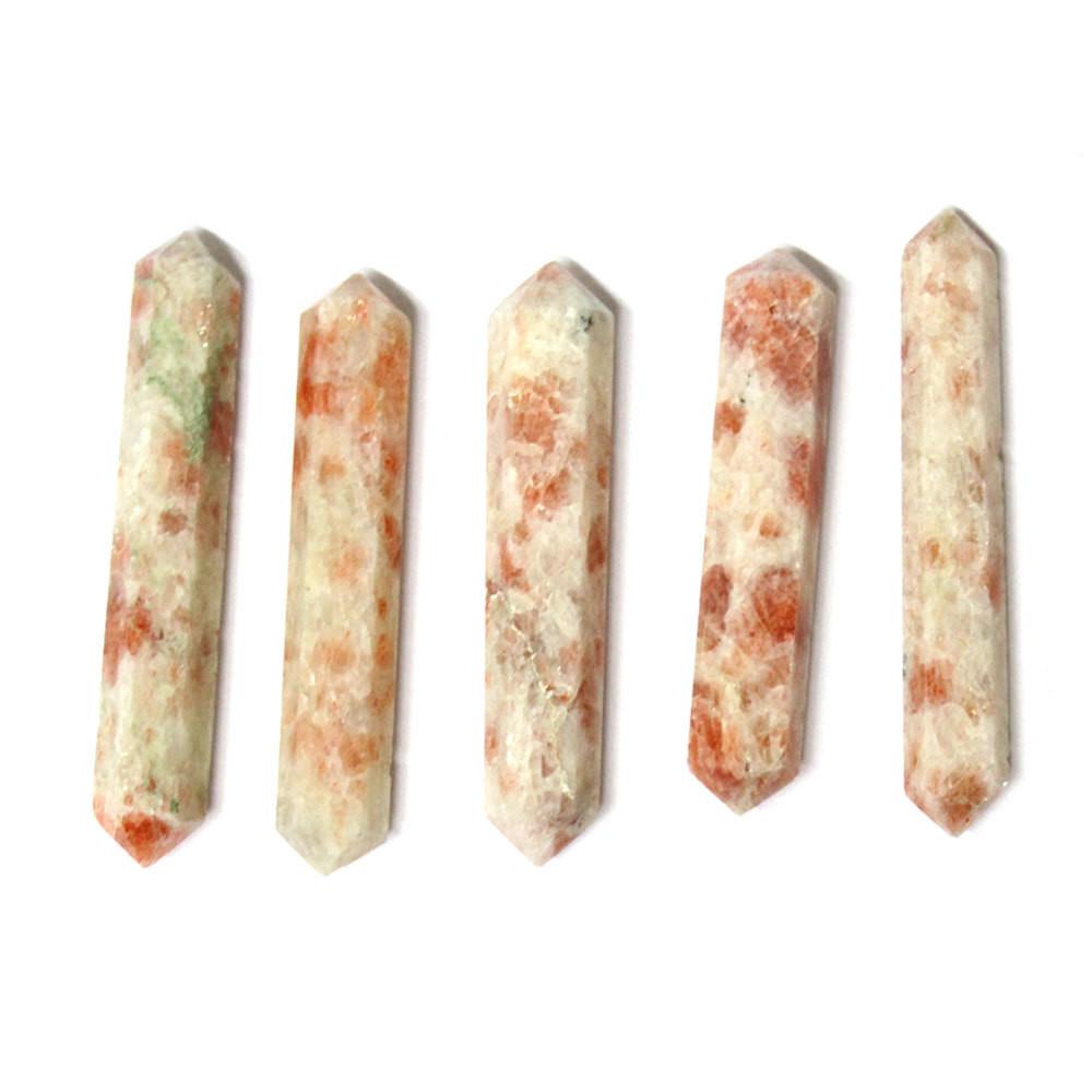 5 sunstone double terminated points lined up on white background