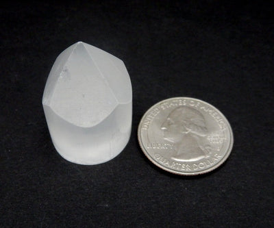 selenite point with quarter for size reference
