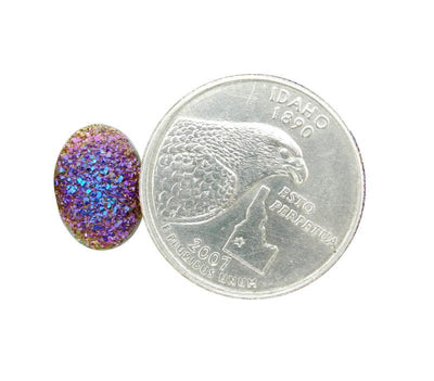 Purple And Yellow Oval Druzy Cabochon pictured next to a quarter for size reference.