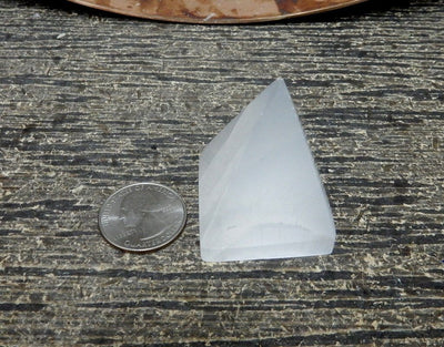 selenite pyramid with quarter for size reference 