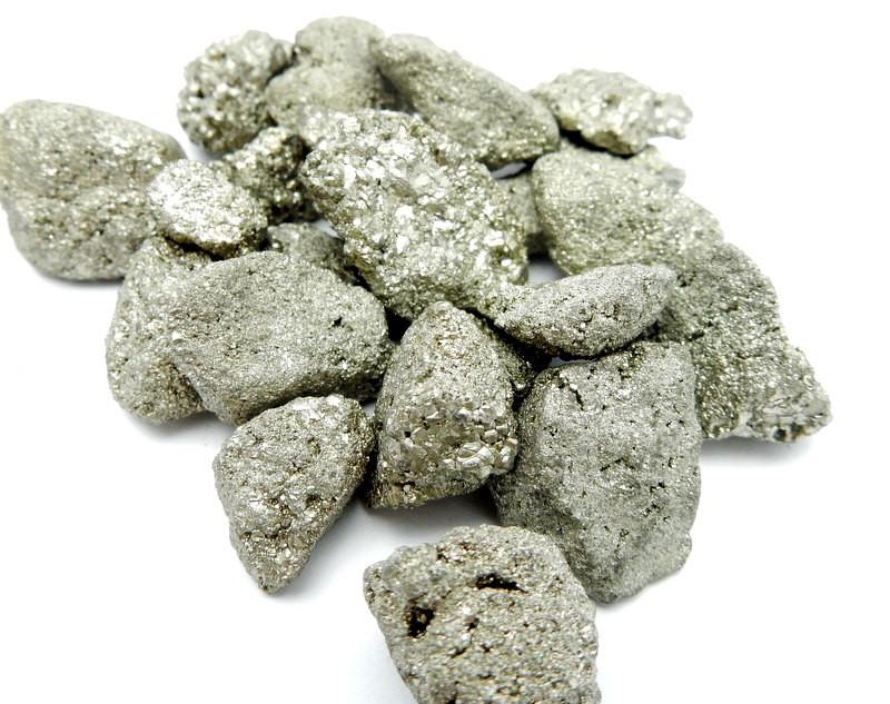 pile of pyrite nuggets on white background