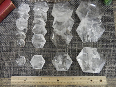 ruler next to different sized hexagonal pocket stones