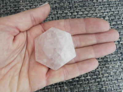 Hexagonal Rose Quartz Polished Stone in hand for size reference 