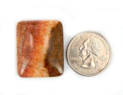 1 Rainbow Calcite Cabochon in a rectangular shape next to quarter for size comparison