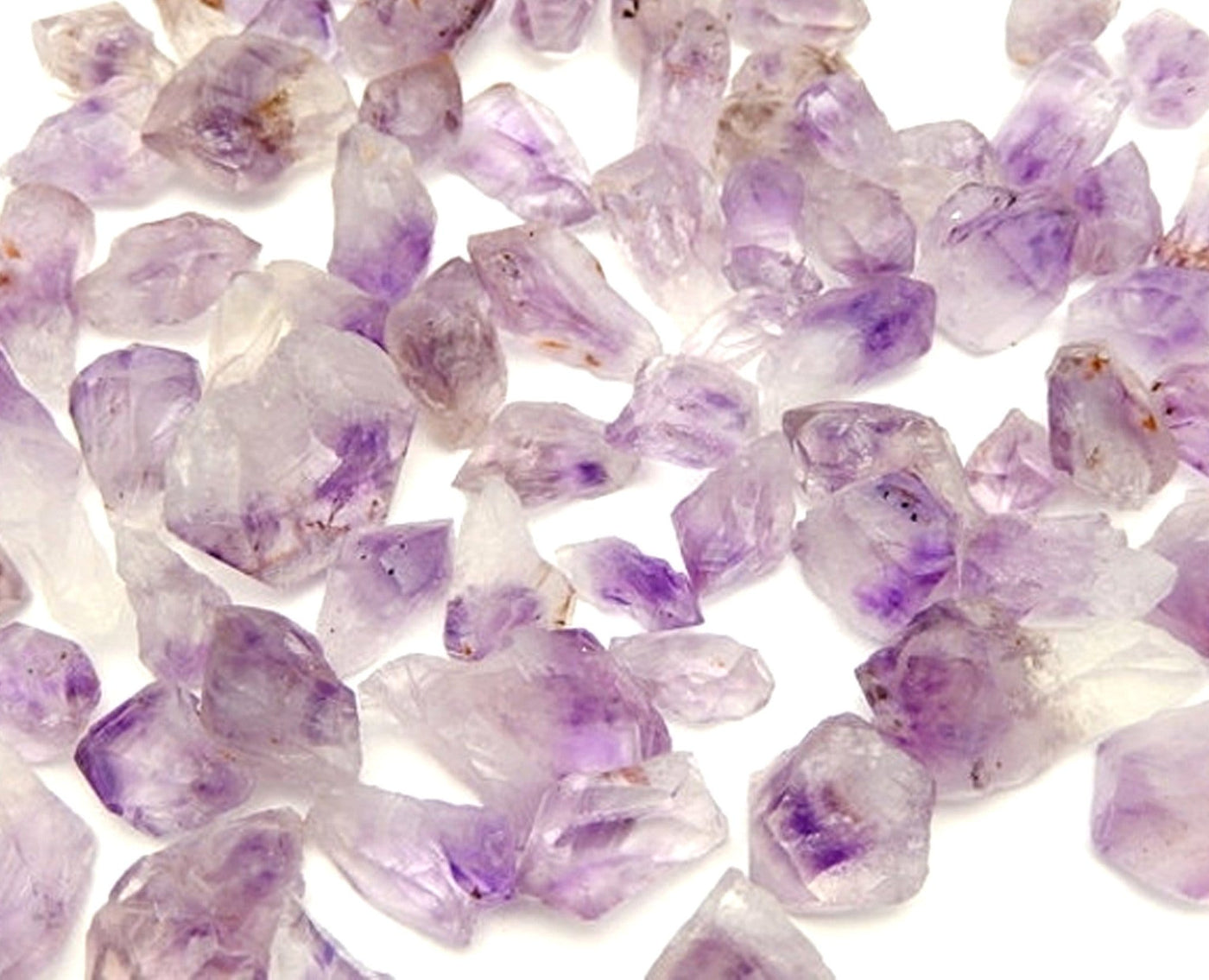 Raw Amethyst Points scattered on white background
