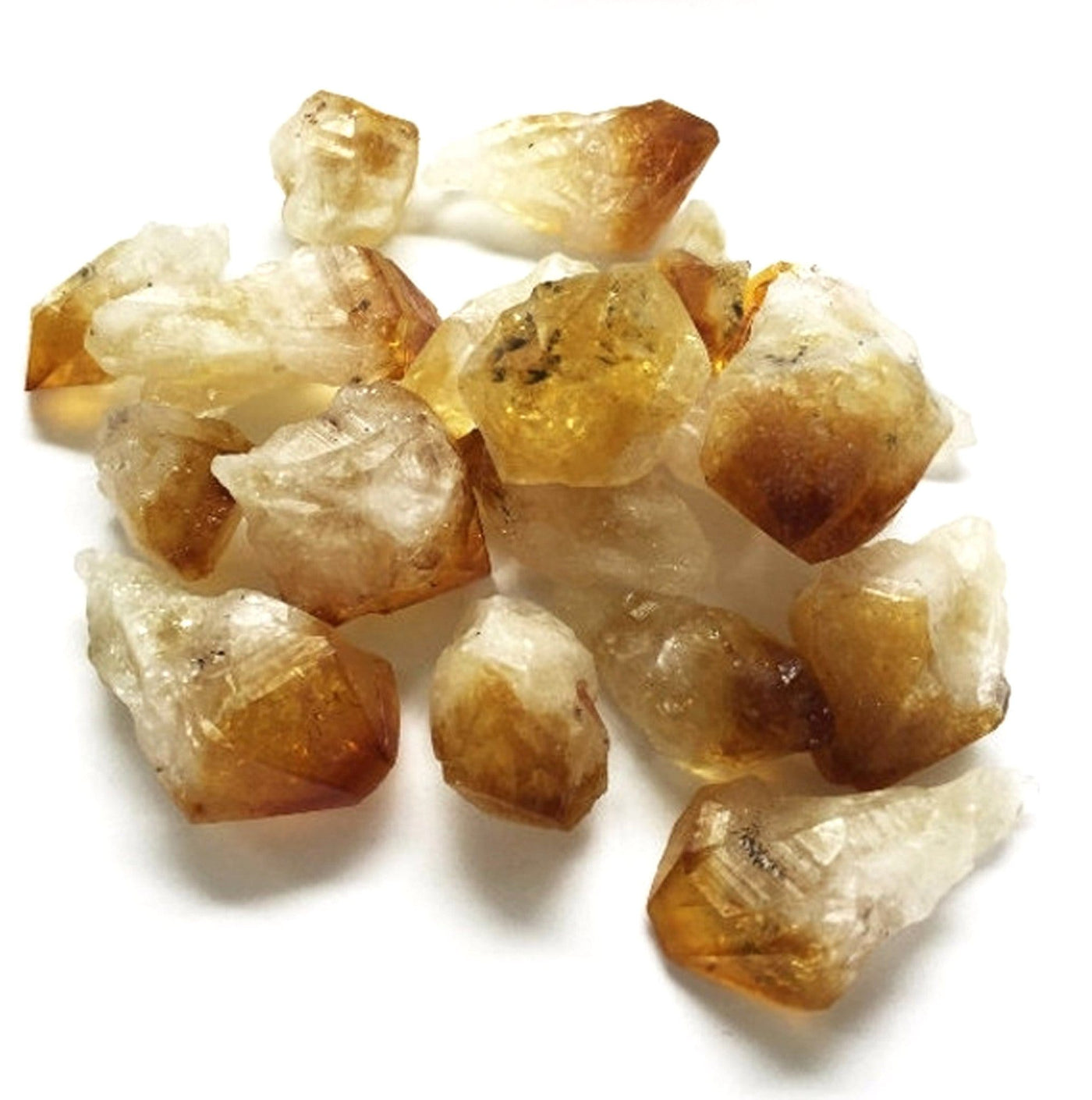 Raw Points - citrine in a pile on a table