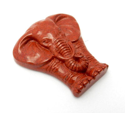 Angled shot of Red Jasper Elephant Cabochon on white background