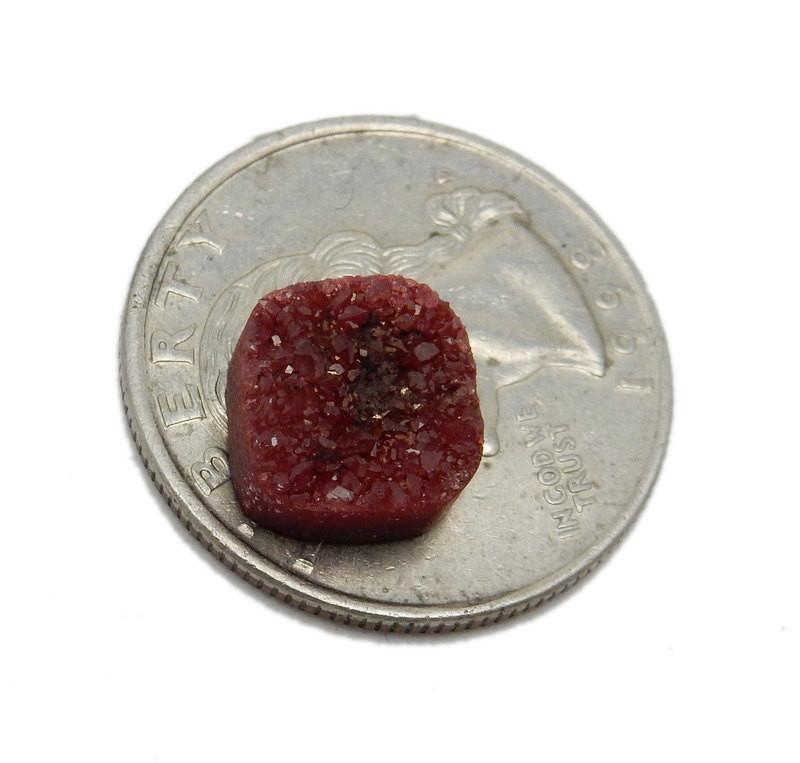 Red Square Druzy on top of quarter for size comparison on white background