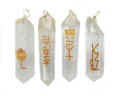 4 Reiki Crystal Quartz Point Pendants lined up on white background