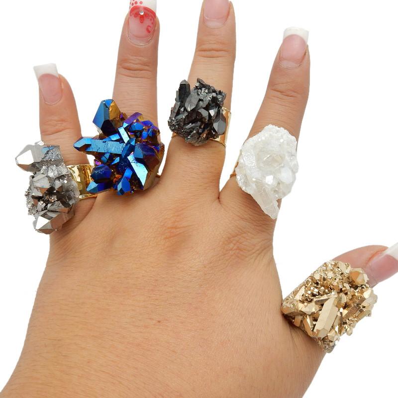 5 different crystal rings on a hand