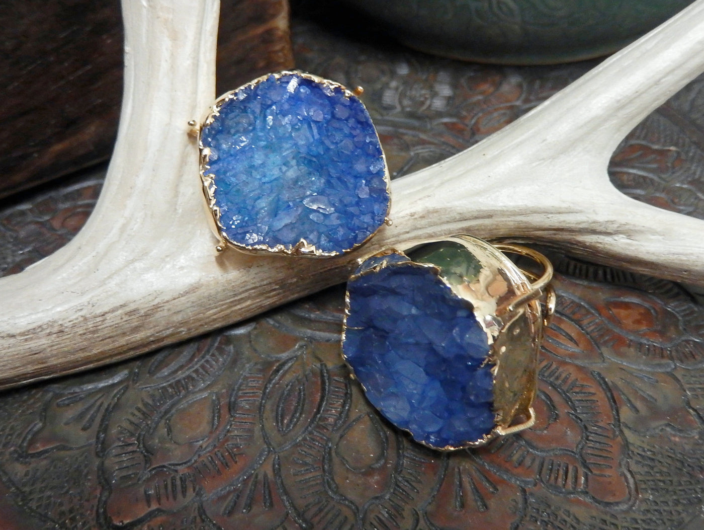 front and side view of blue druzy rings in gold