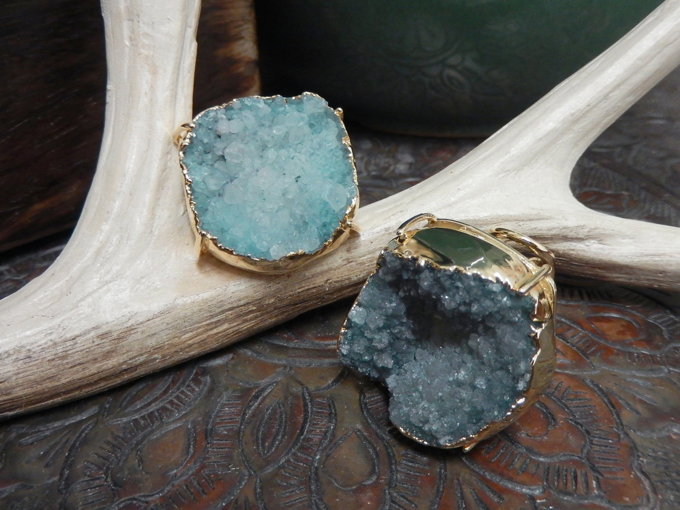 front and side view of teal druzy rings in gold