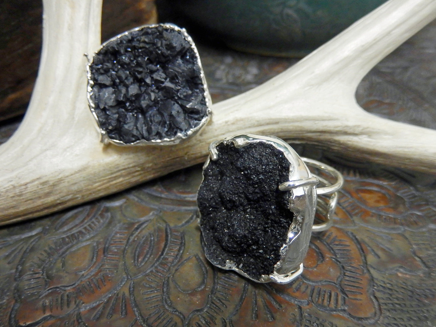 front and side view of dark druzy rings in silver