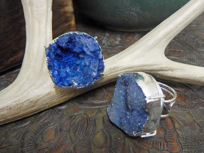 front and side view of blue druzy rings in silver