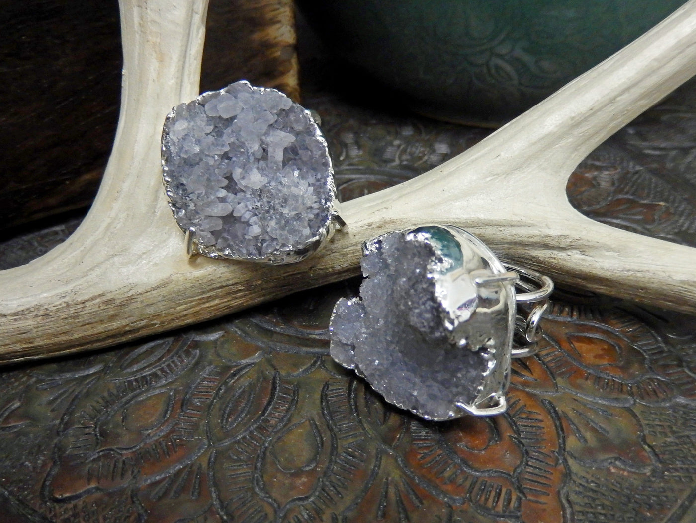 front and side view of light gray druzy rings in silver